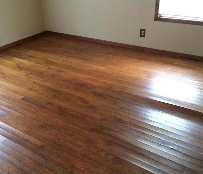 storm damaged hardwood floor after SERVPRO