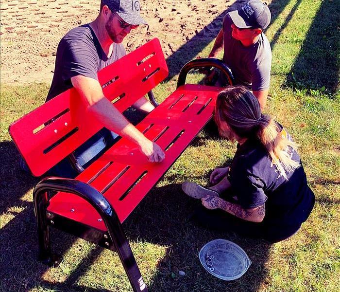 Servpro crew helping assemble bench at new Bethany Park